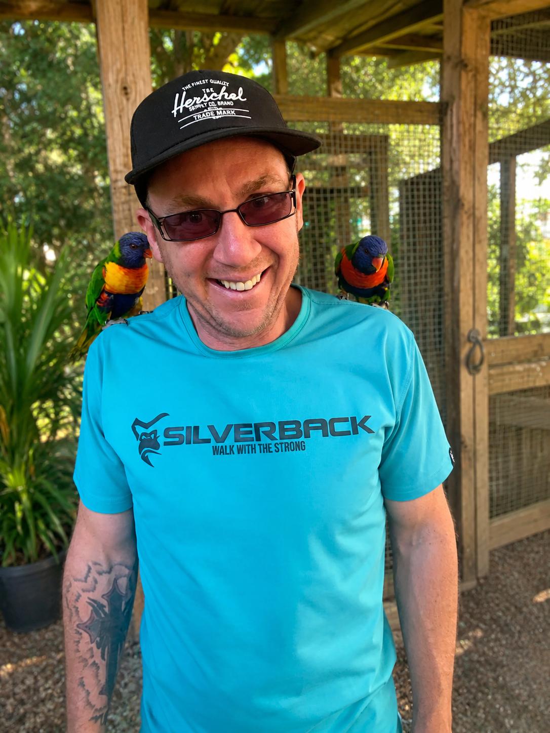 Glen with rainbow lorikeets at a wildlife park